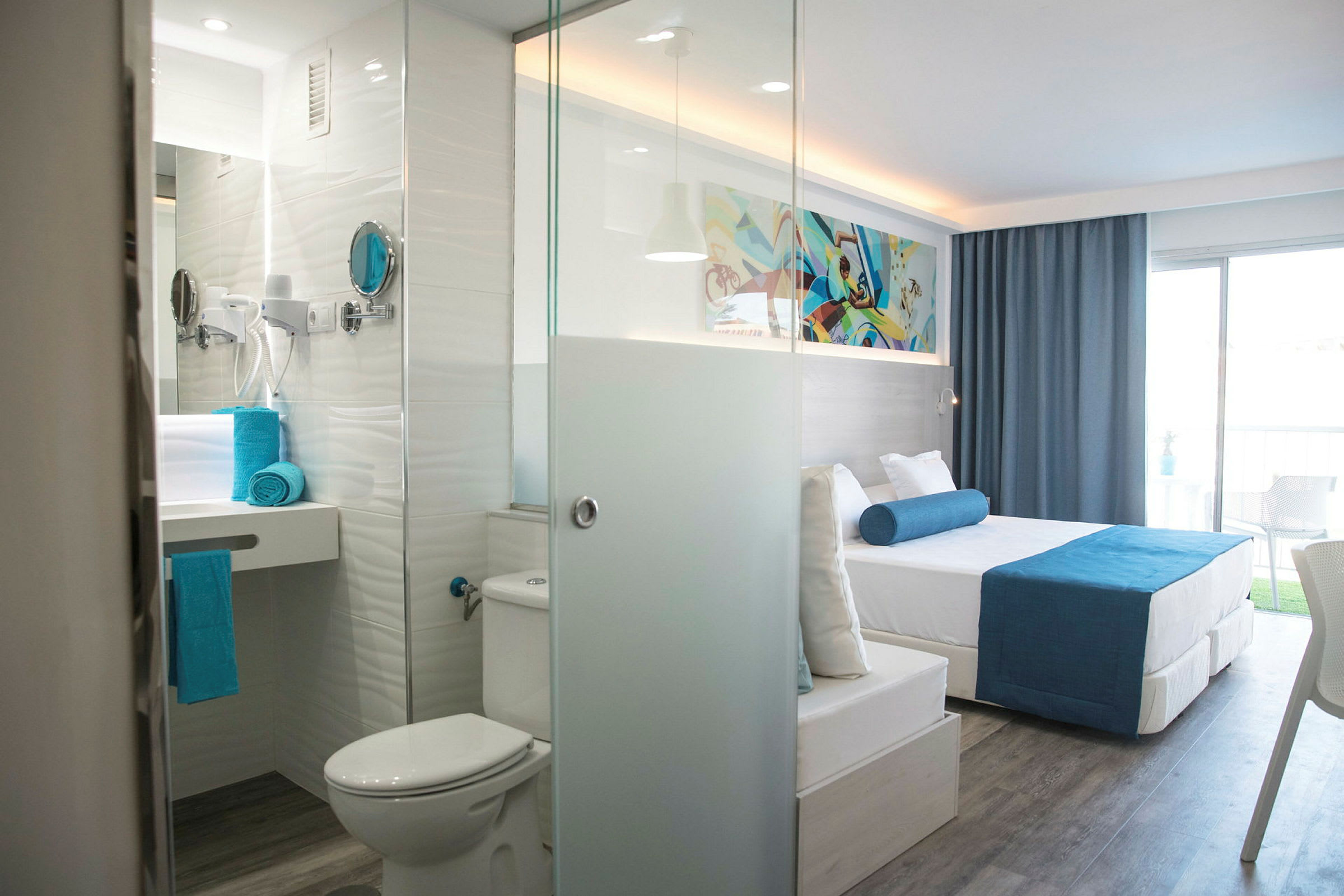 Moderne hotellrom med seng, bad og balkong. (AI-generert tekst)