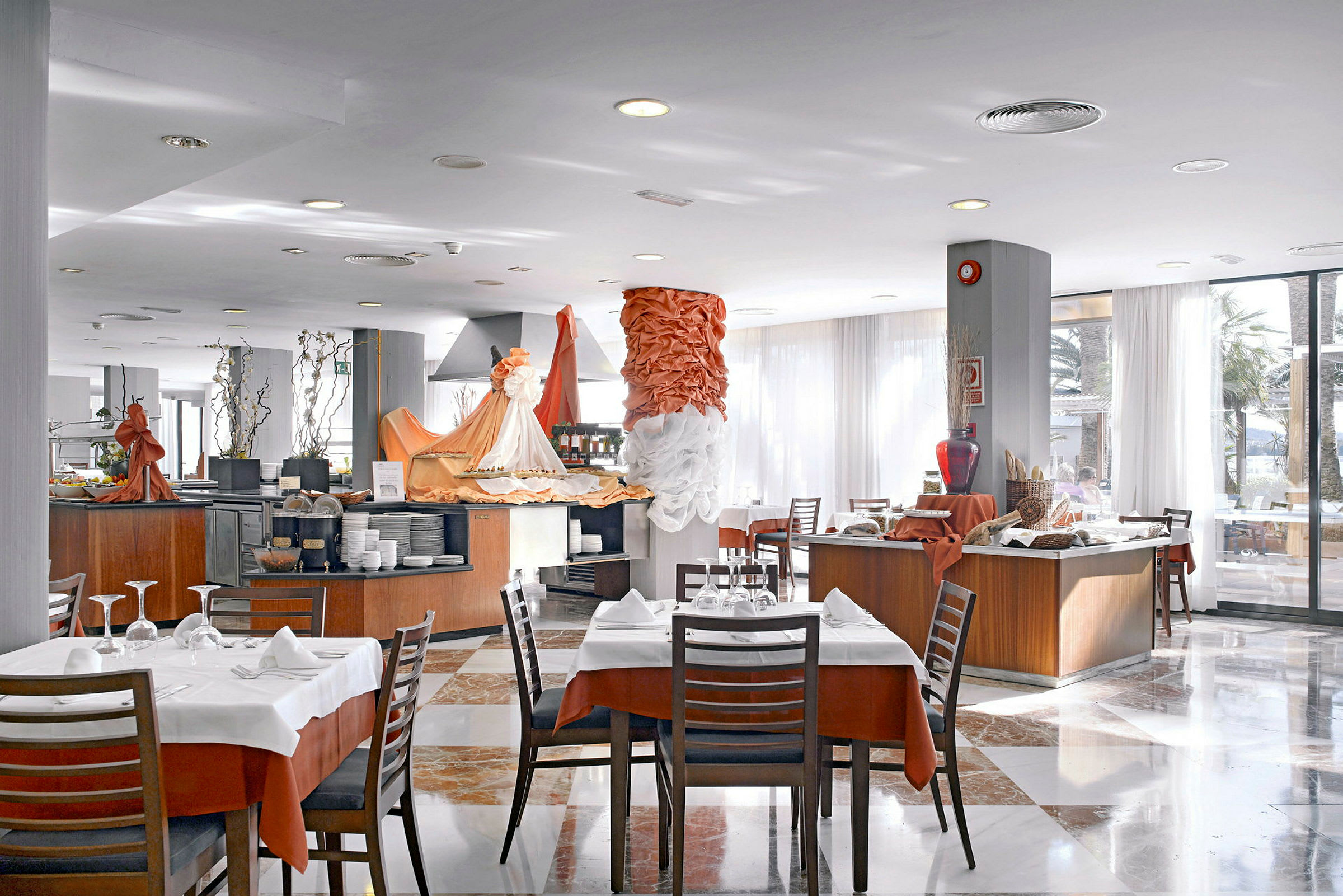 Interiør av en lys restaurant med flere oppdekkede bord og buffetlinjer. (AI-generert tekst)