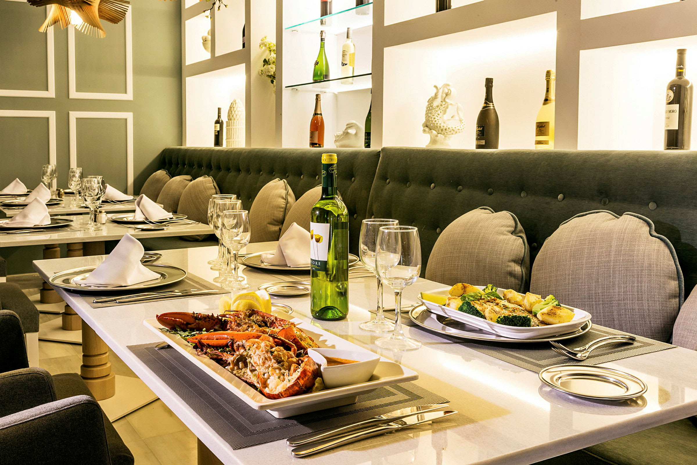 Et dekket restaurantbord med tallerkener og mat, inkludert skalldyr og grønnsaker. (AI-generert tekst)