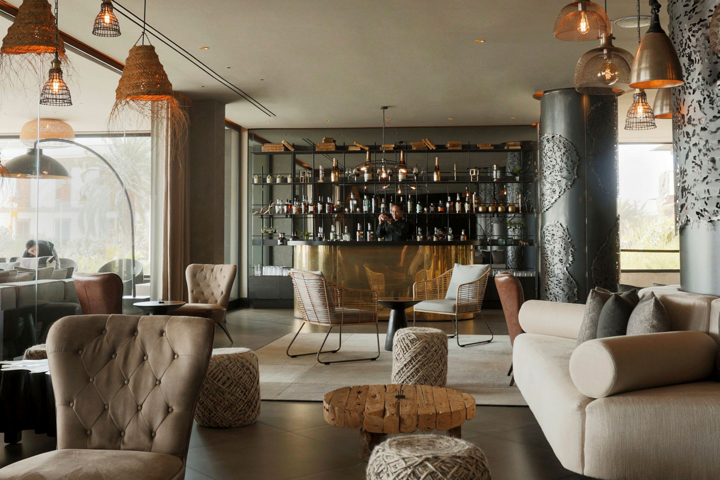 En stilfull hotellounge med elegant innredning, sittegrupper og en velutstyrt bar. (AI-generert tekst)
