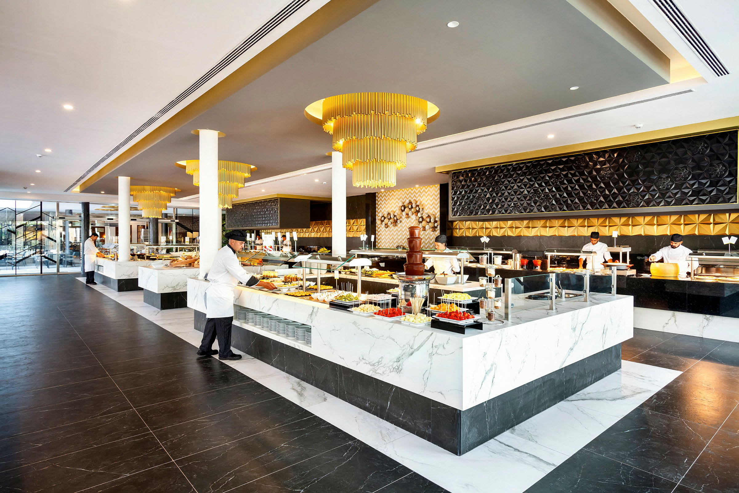 En elegant restaurantbuffé med moderne innredningsdetaljer og marmorstasjoner fylt med ulike matretter. (AI-generert tekst)