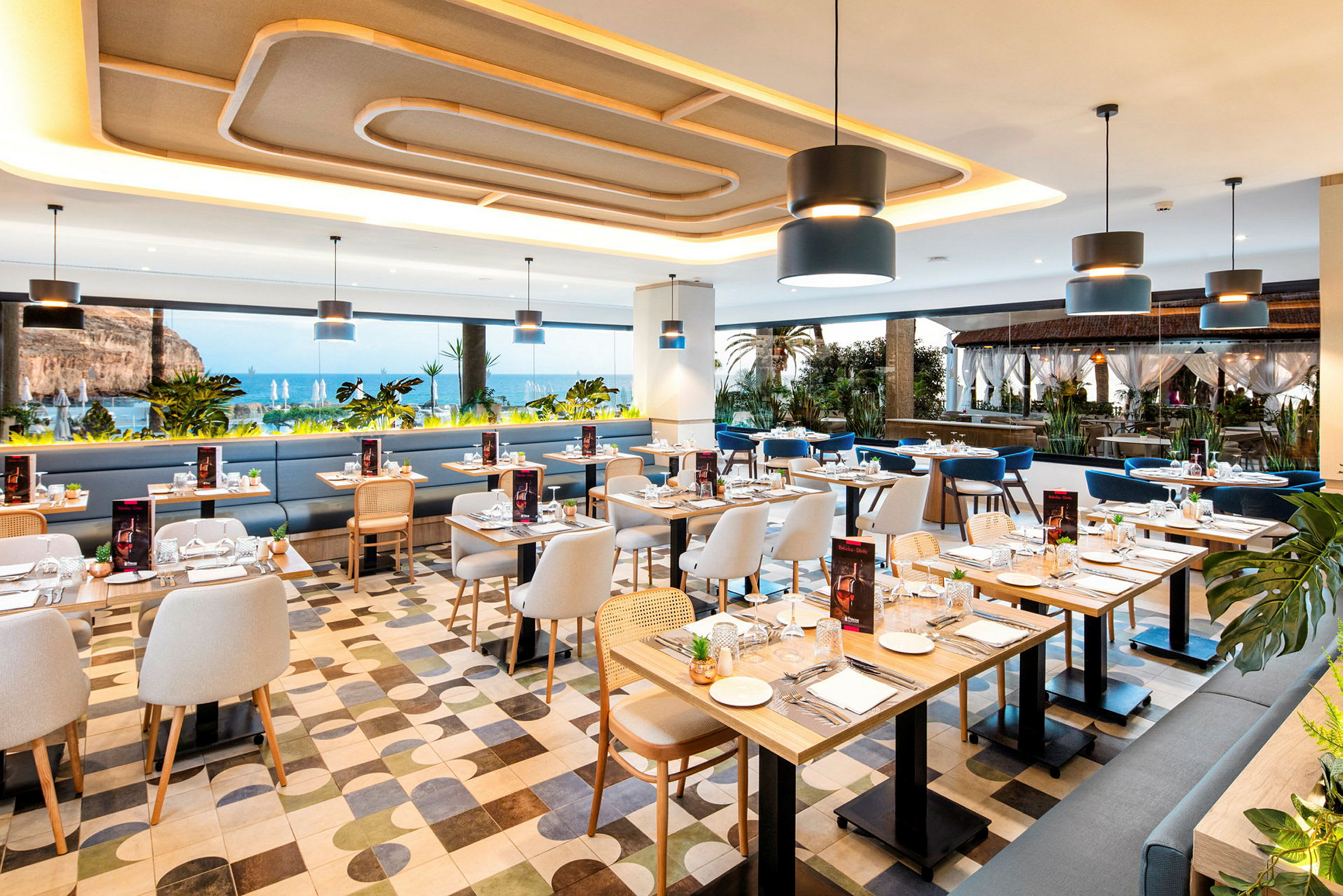 Interiør av en restaurant med havutsikt, moderne møbler og oppdekkede bord. (AI-generert tekst)