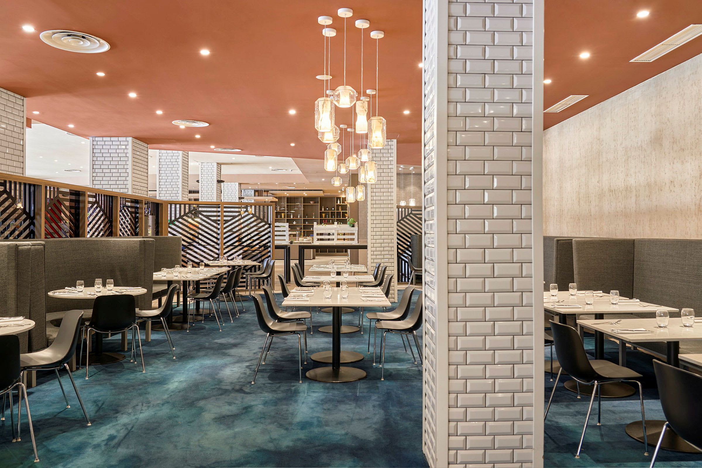 En moderne restaurant med stilfull innredning, blått gulv og elegante bord. (AI-generert tekst)