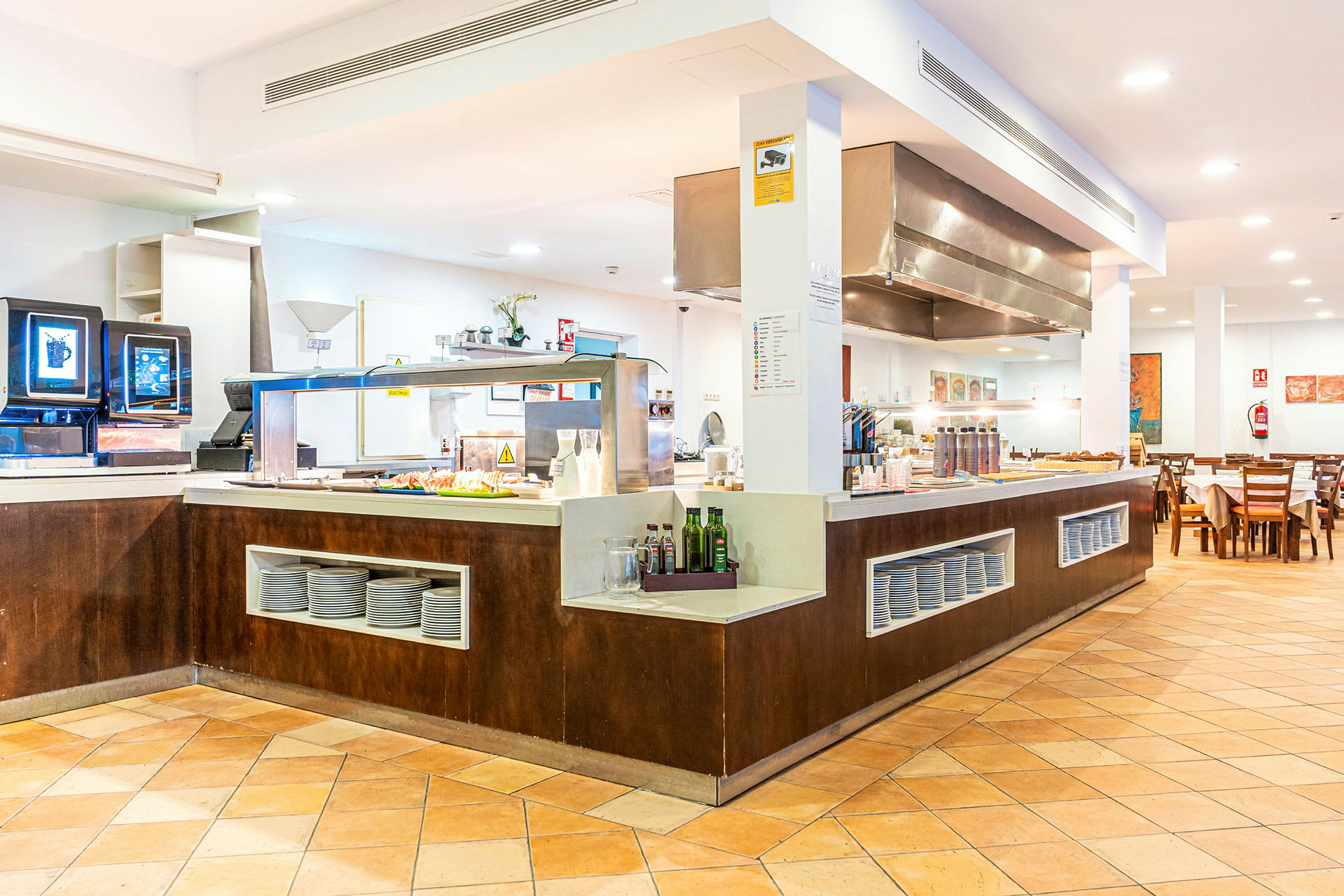 Et buffetområde i en restaurant med servering av mat og sitteplasser. (AI-generert tekst)