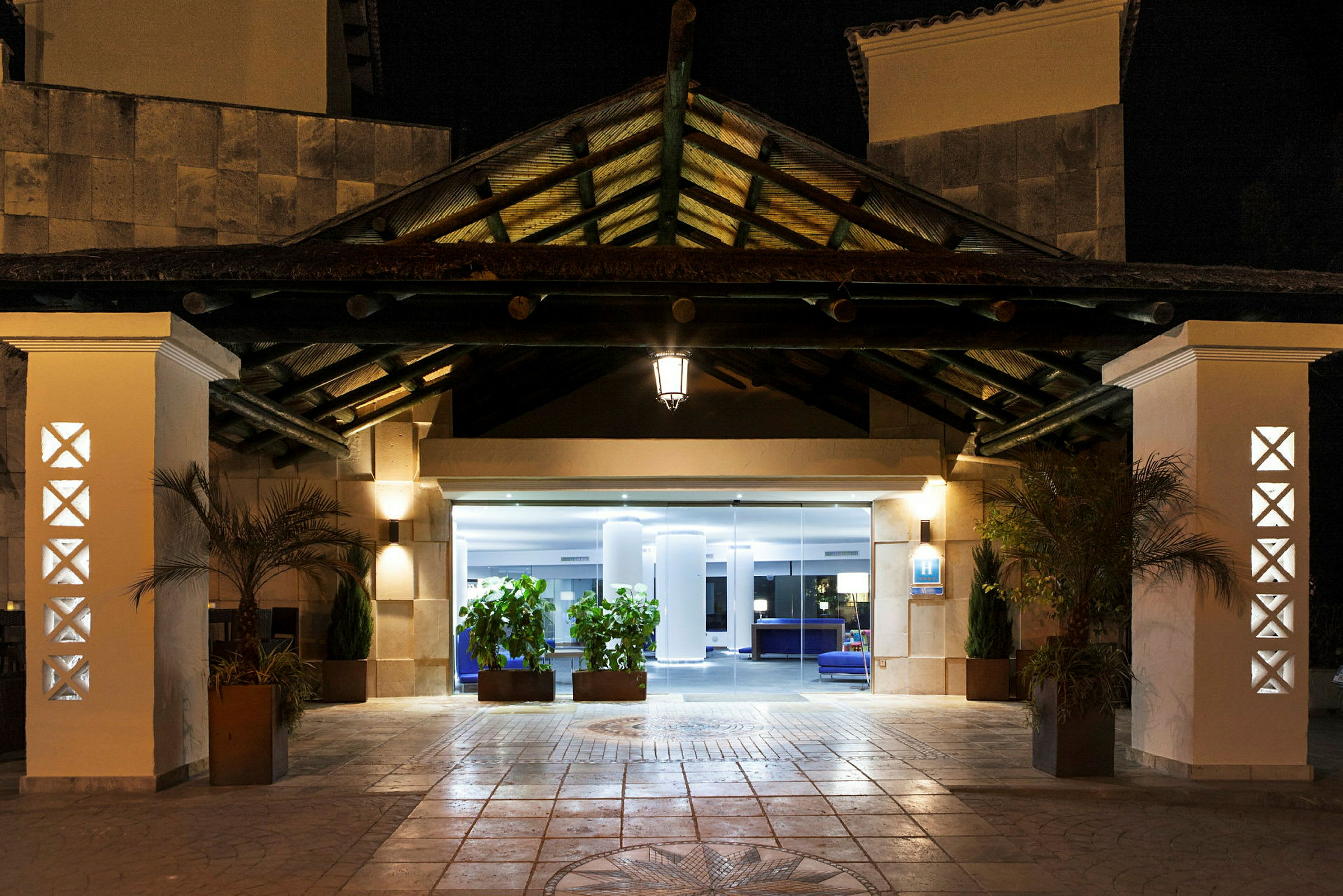 Hotellinngang opplyst om kvelden. (AI-generert tekst)