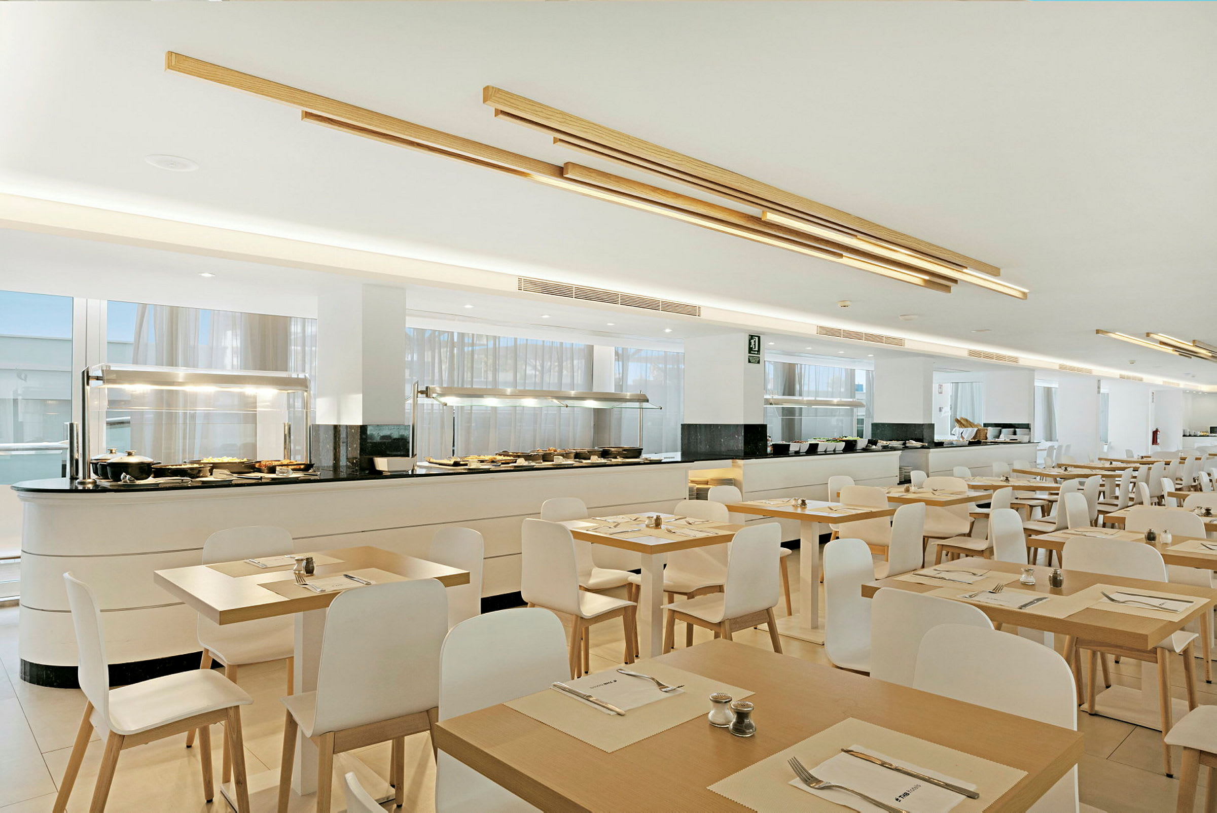 En romslig restaurant med dekkede bord og buffet. (AI-generert tekst)
