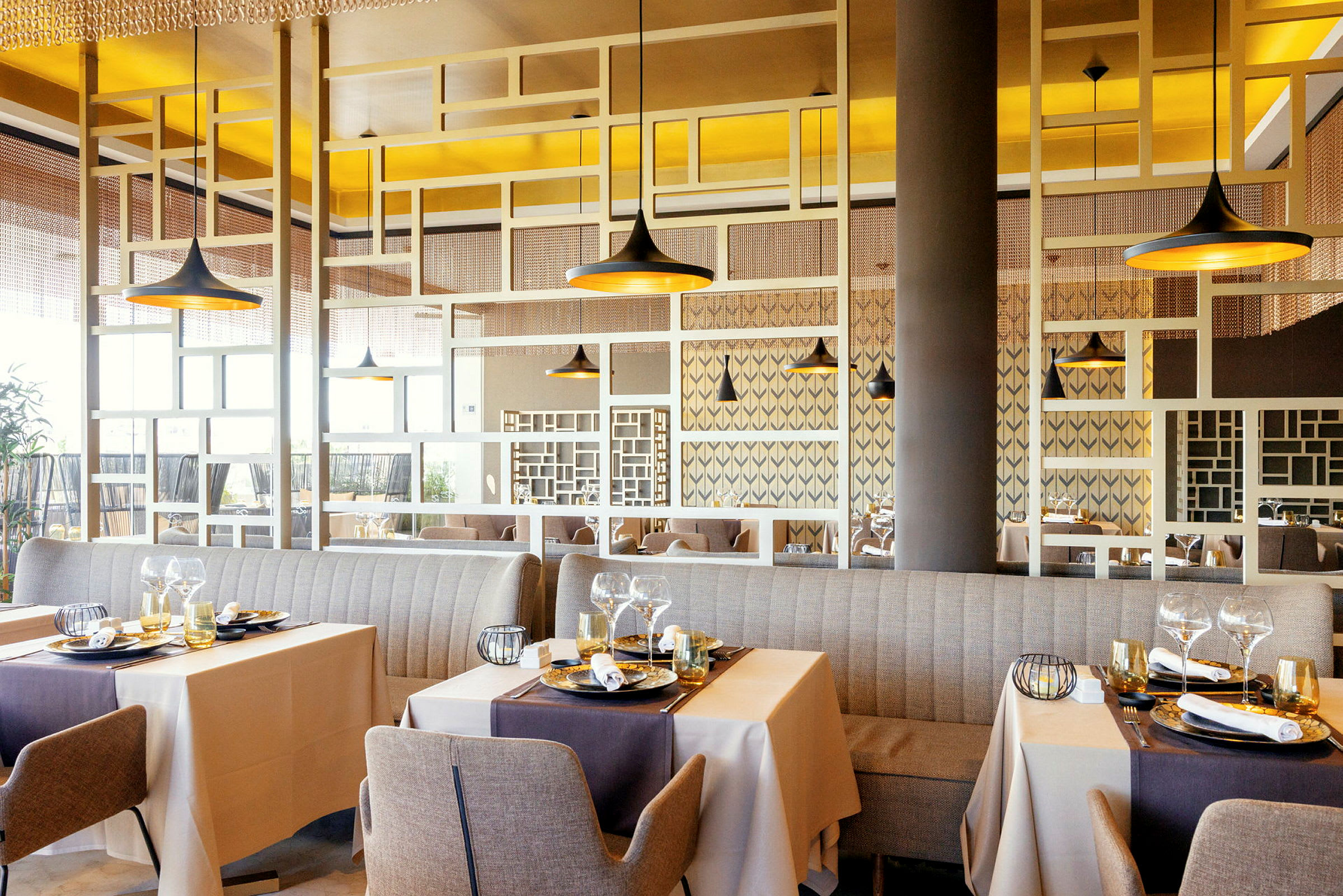 Bilde av en elegant restaurant med bord dekket til måltider og moderne dekorative detaljer. (AI-generert tekst)