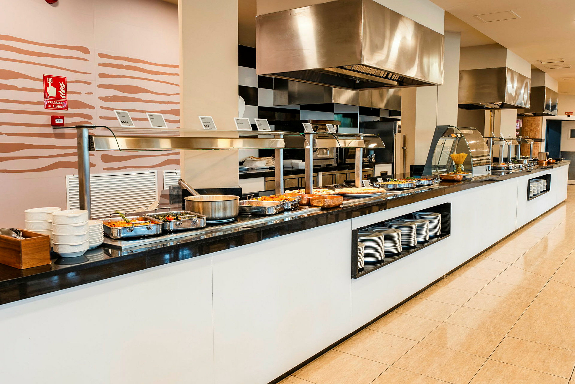 Buffet med ulike retter, tallerkener og bestikk ved siden. (AI-generert tekst)
