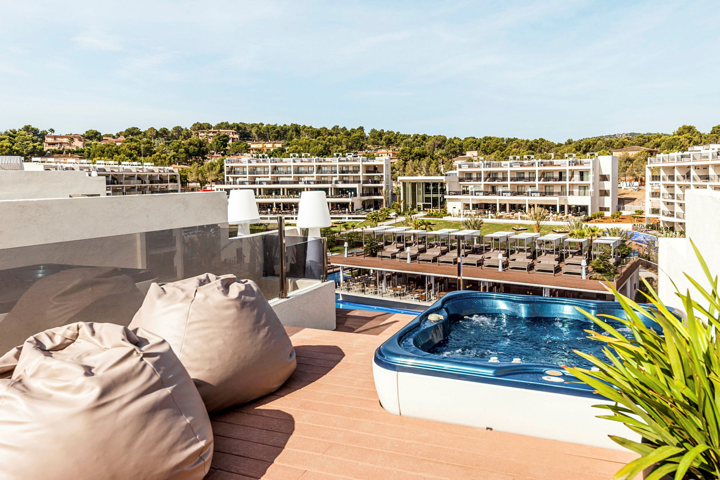Terrasse med boblebad og utsikt over hotellområdet. (AI-generert tekst)