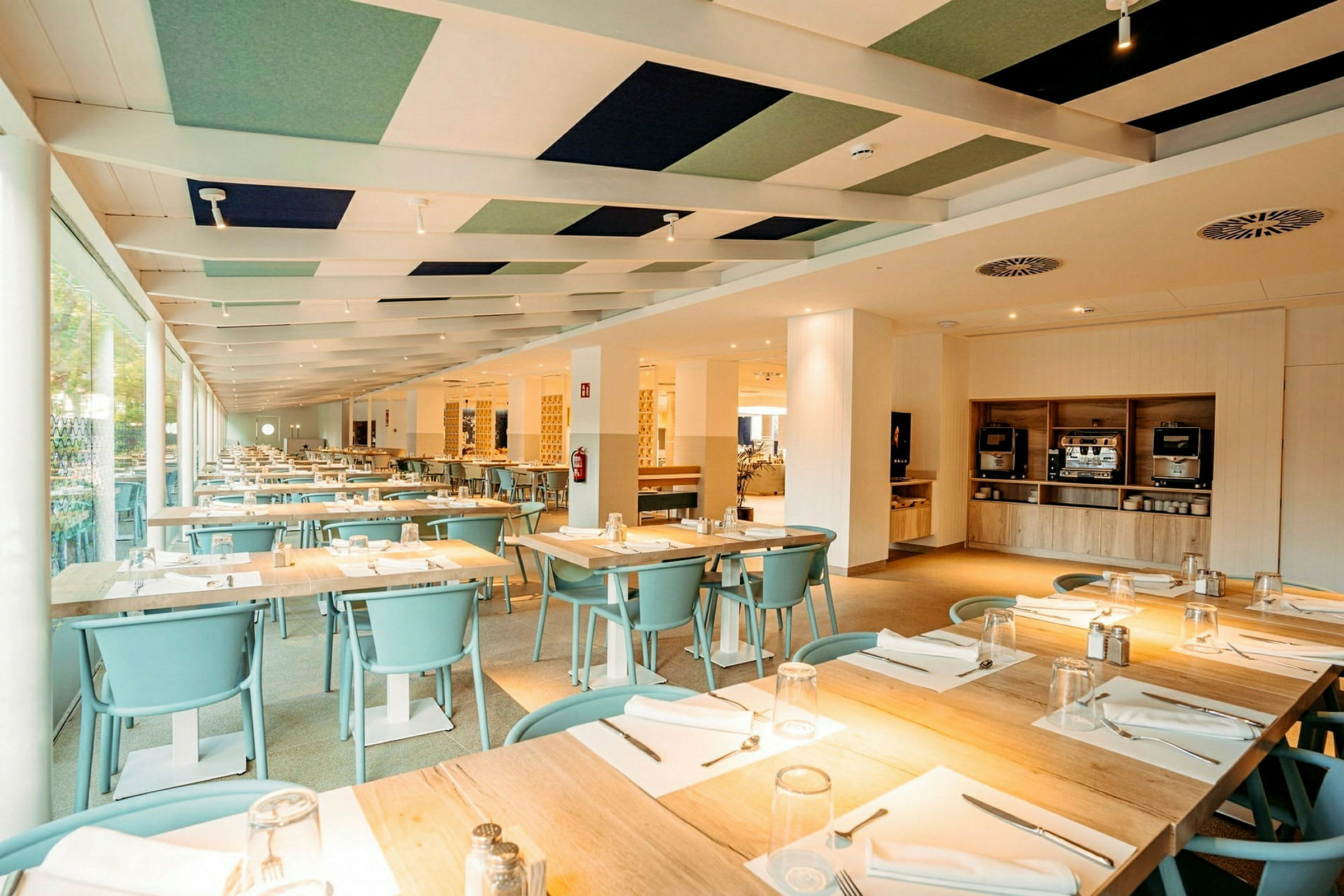 Innendørs omgivelser av en restaurant med dekkede bord og lys innredning. (AI-generert tekst)