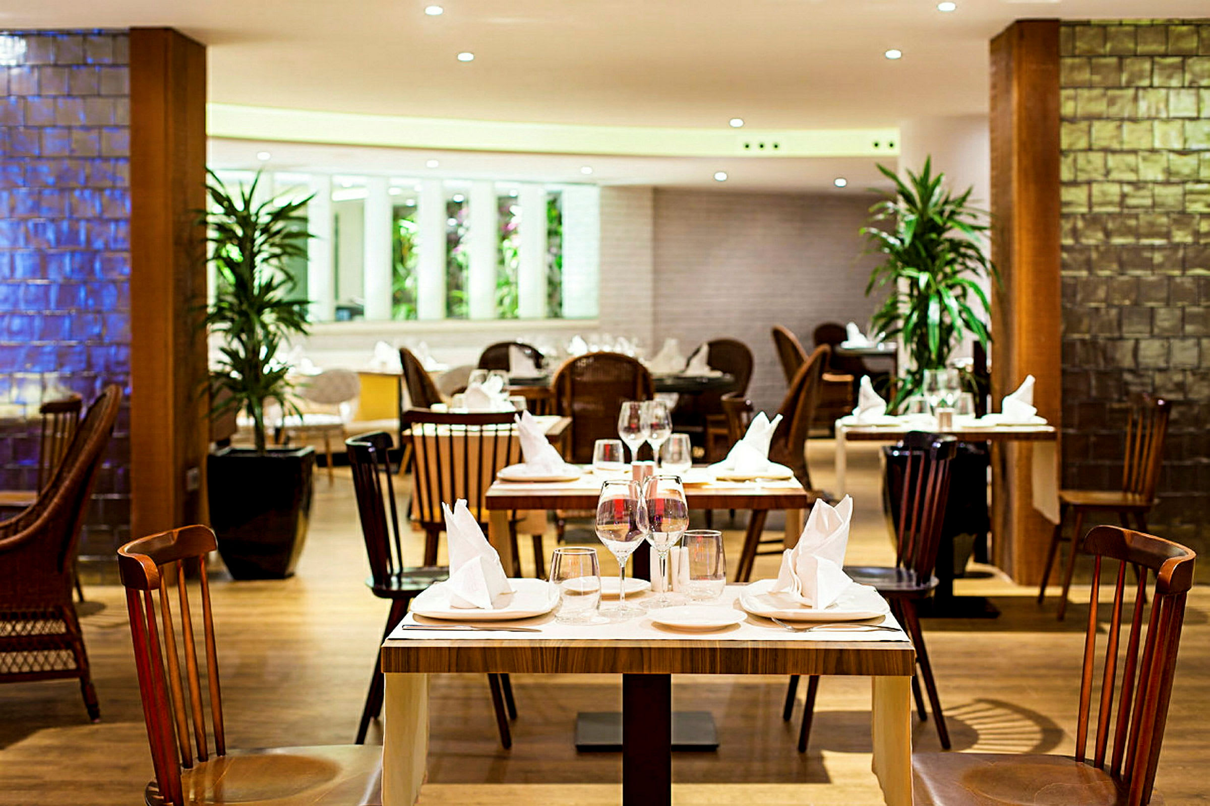 Interiør av en elegant restaurant med dekkede bord og stoler. (AI-generert tekst)
