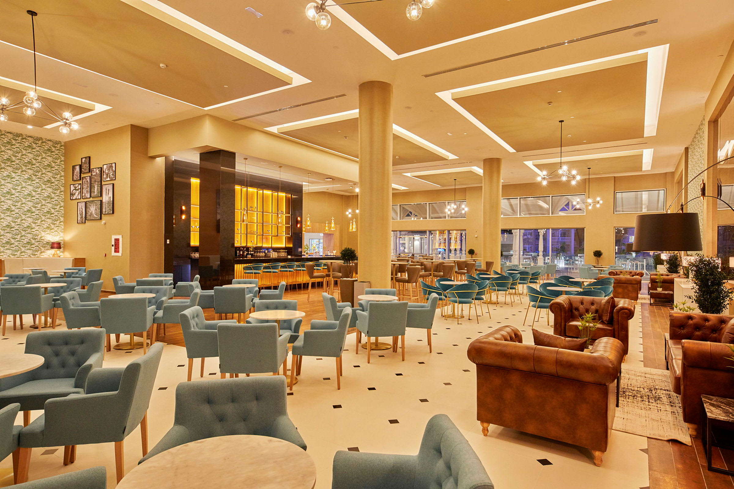 Et moderne hotellområde med sittegrupper og en opplyst bar. (AI-generert tekst)