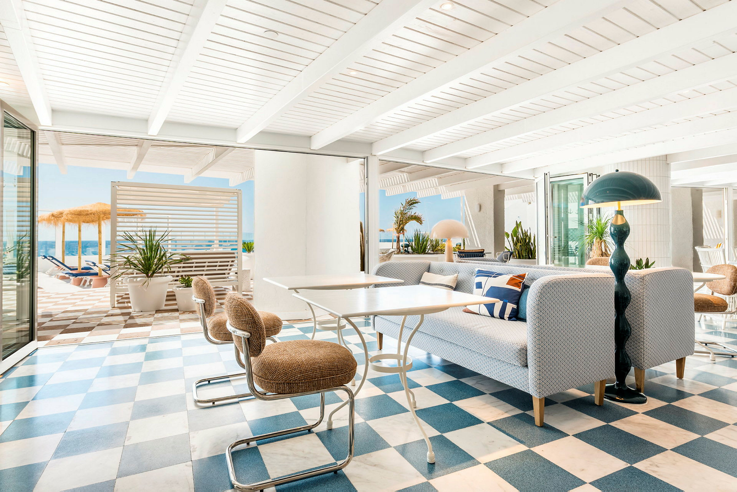 Lys og moderne lounge med rutete gulv og utsikt mot en solterrasse. (AI-generert tekst)