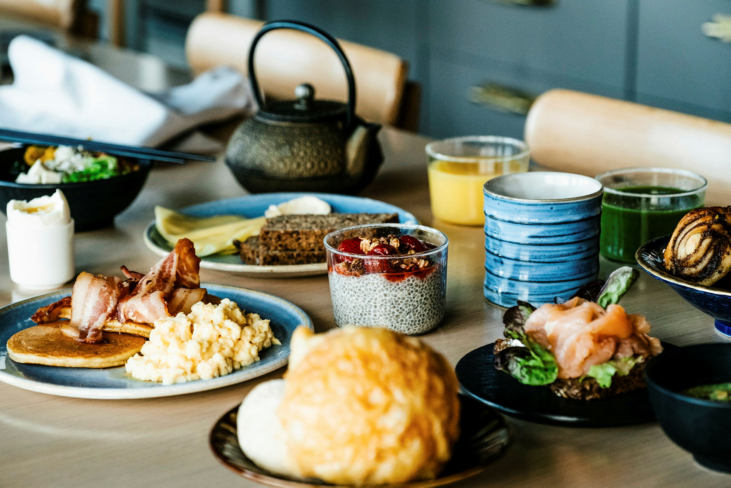 En frokost med forskjellige retter og drikker oppstilt på et bord. (AI-generert tekst)