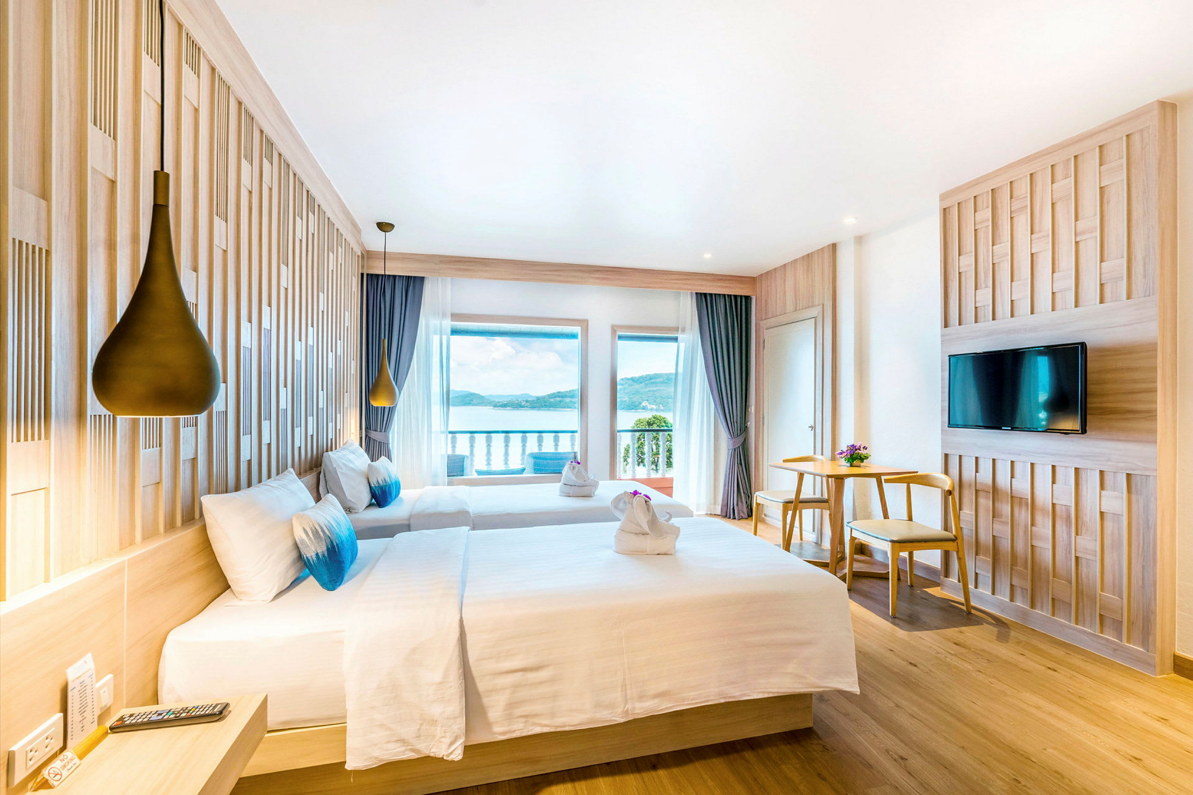 Hotellrom med to senger, utsikt over havet og moderne innredning. (AI-generert tekst)