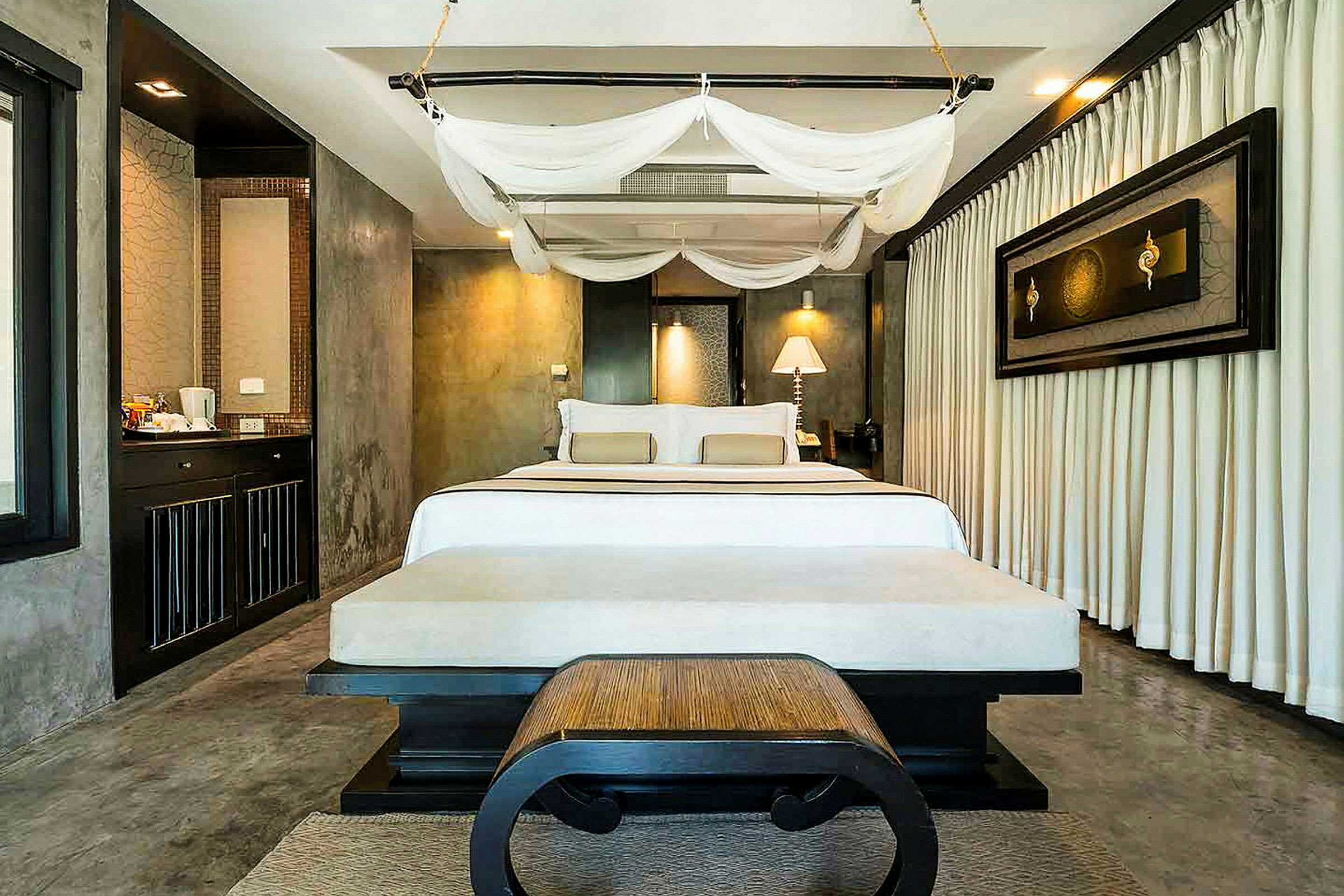 Et hotellrom med en dobbeltseng, myggnett og elegant innredning. (AI-generert tekst)