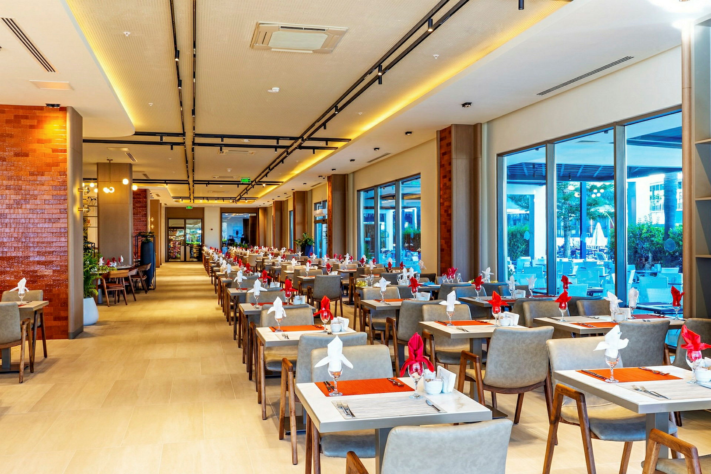 En lys og moderne restaurant med dekkede bord og moderne møbler. (AI-generert tekst)