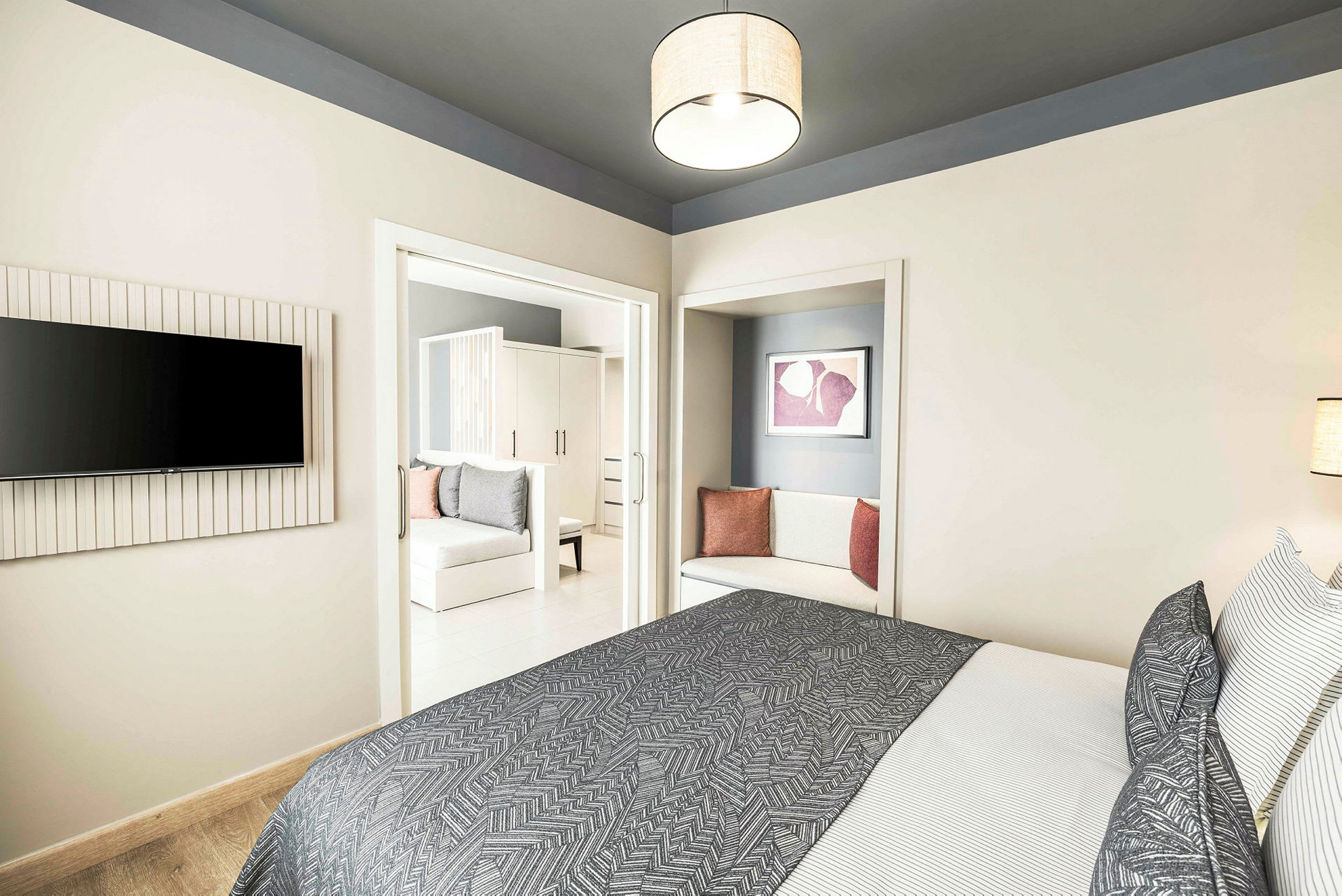 Moderne hotellrom med seng, tekstiler og sitteområde. (AI-generert tekst)