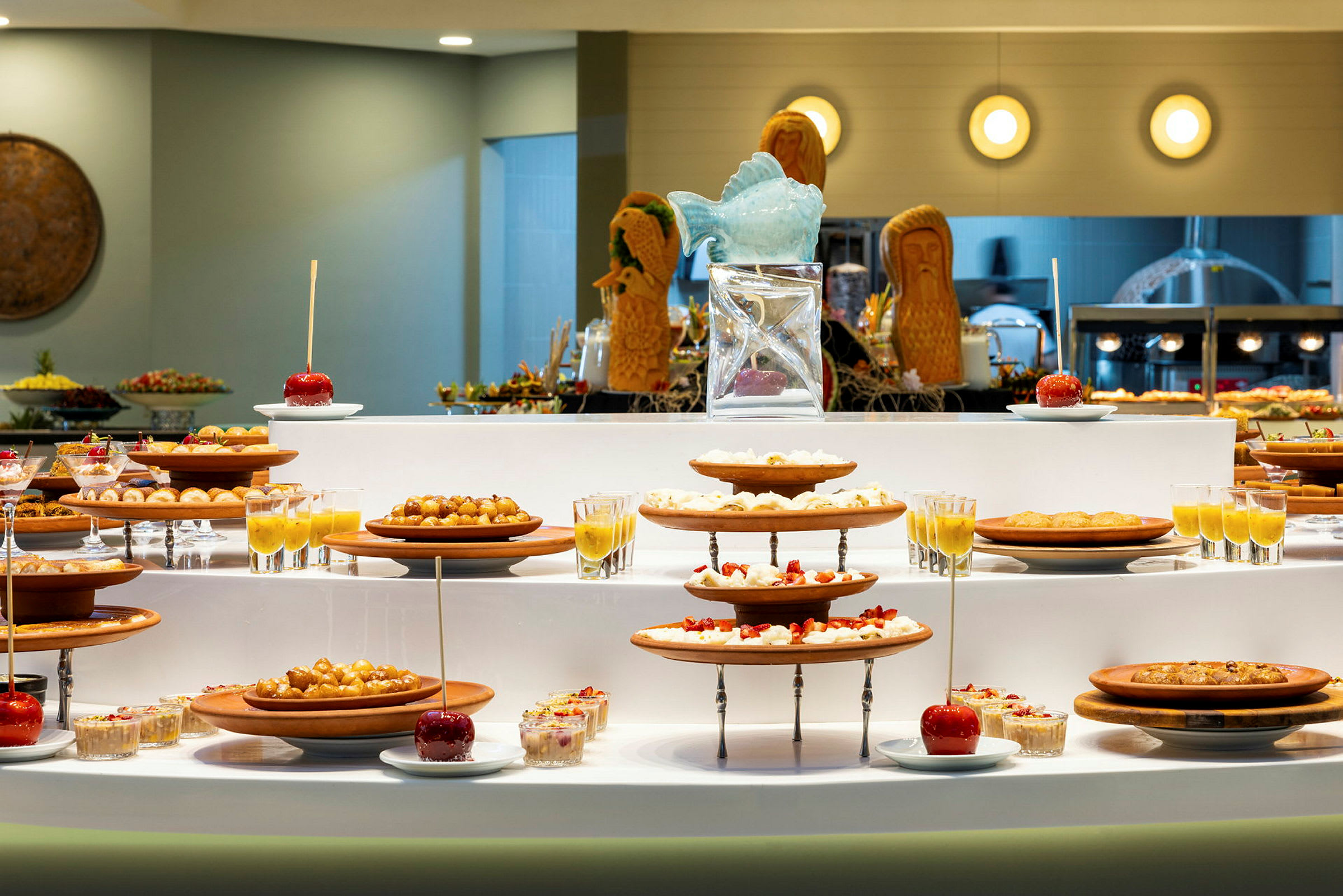 En buffé med forskjellige desserter og frukt plassert på fat og i glass. (AI-generert tekst)