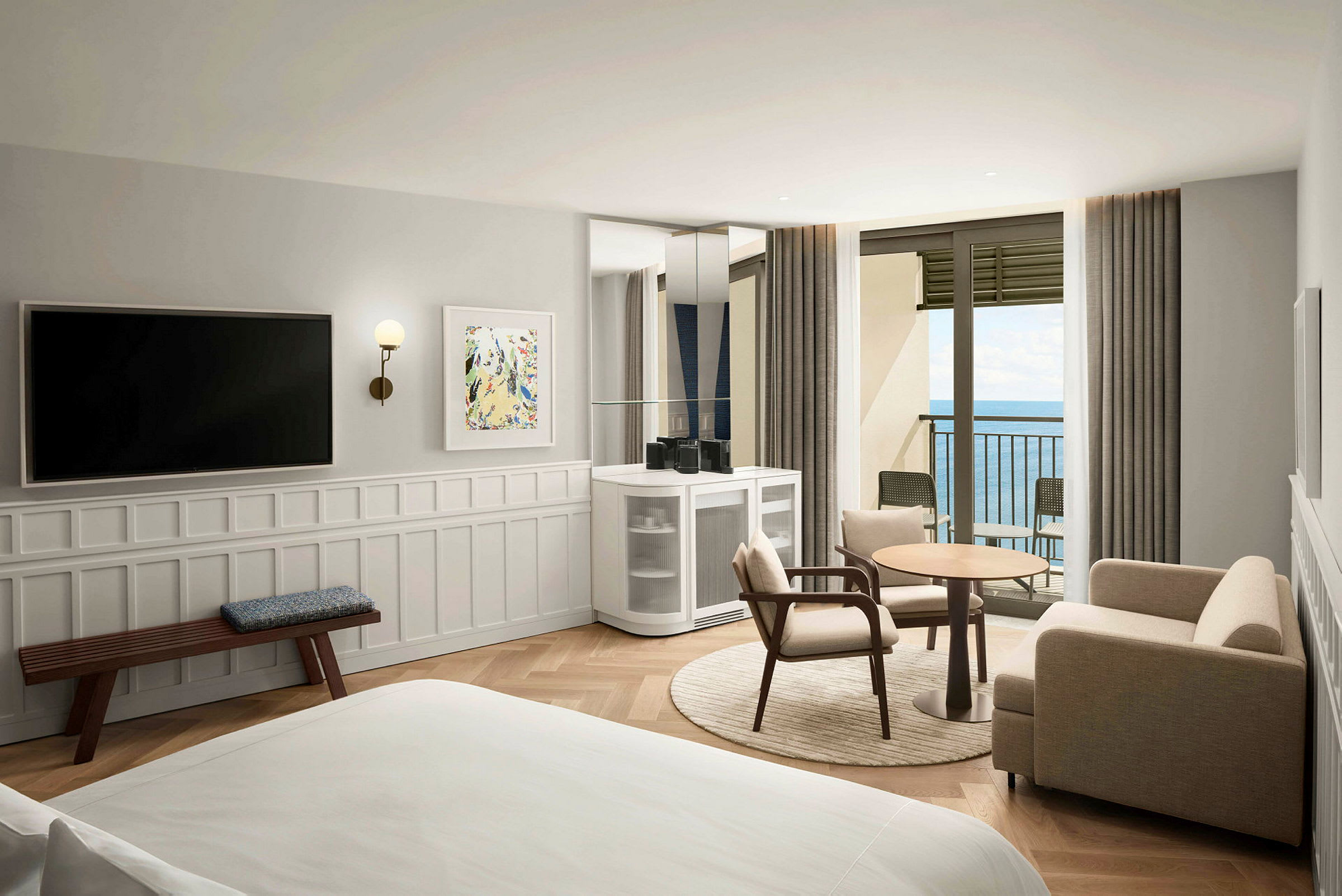 Et hotellrom med moderne innredning, sittemøbler, et bord, en TV og en balkong med utsikt over havet. (AI-generert tekst)