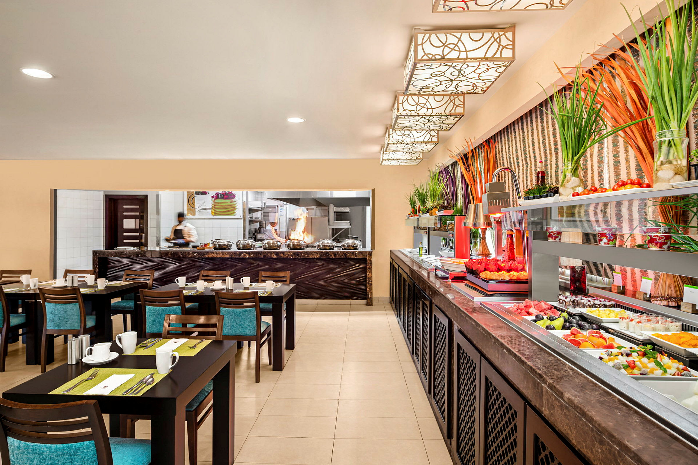 Bilde av et restaurantmiljø med dekkede bord, et åpent kjøkkenområde og en buffet med fersk frukt og grønnsaker. (AI-generert tekst)
