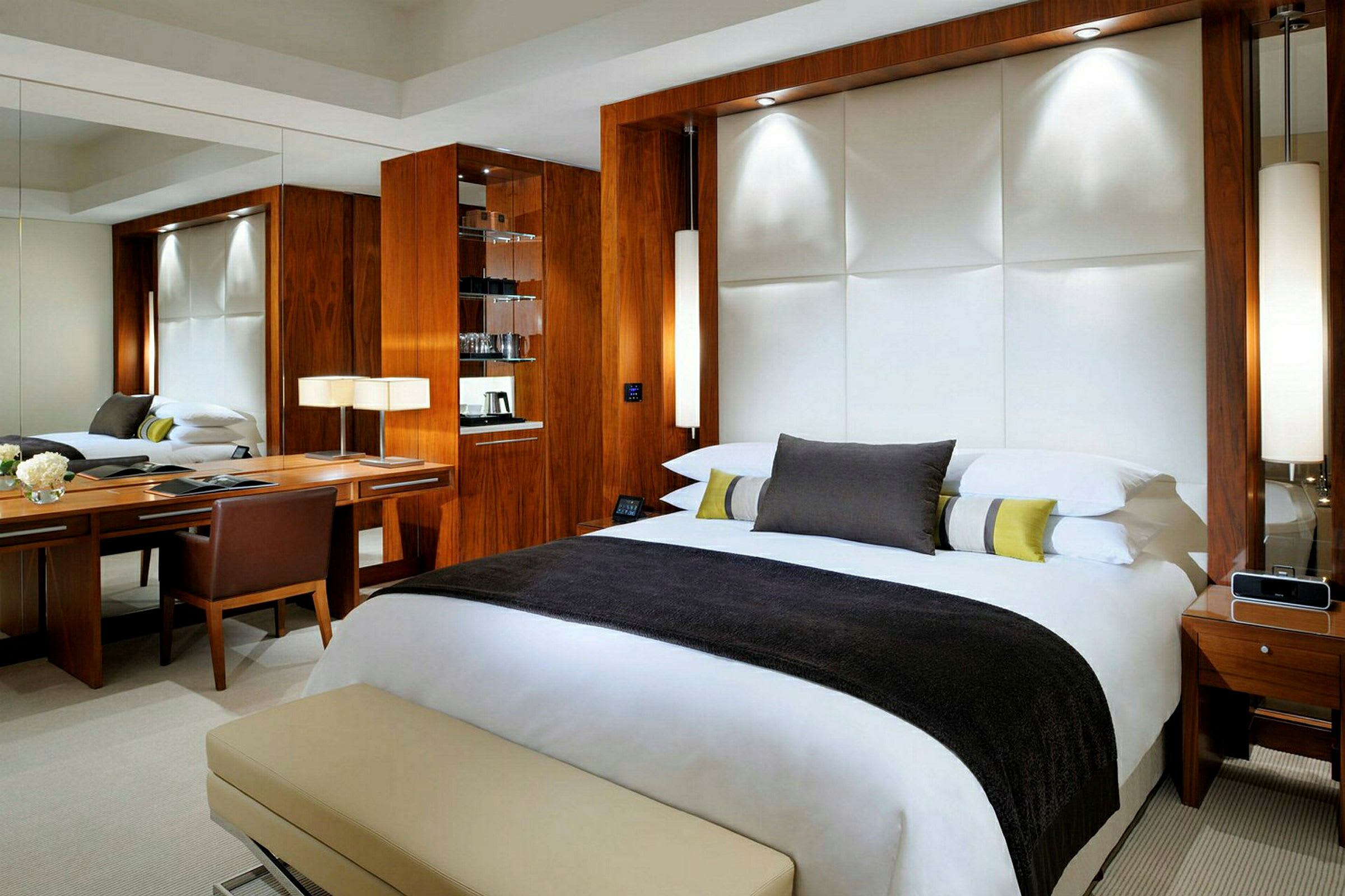 Et moderne hotellrom med en stor seng, skrivebord og trematerialer. (AI-generert tekst)