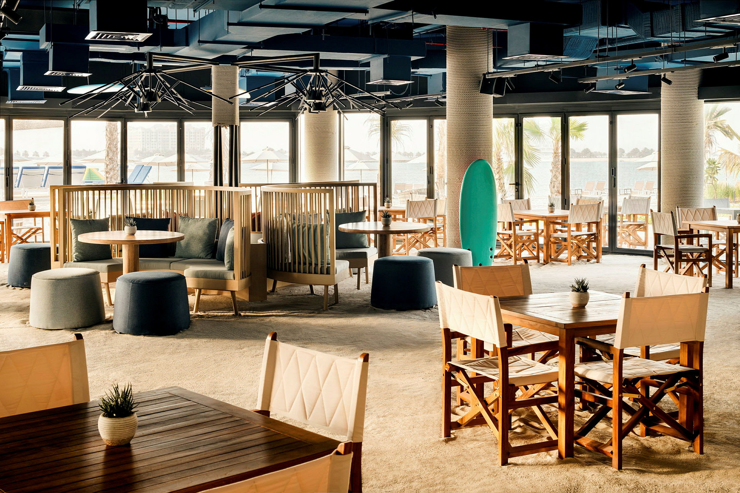 Restaurant med sitteplasser og bord ved stranden. (AI-generert tekst)
