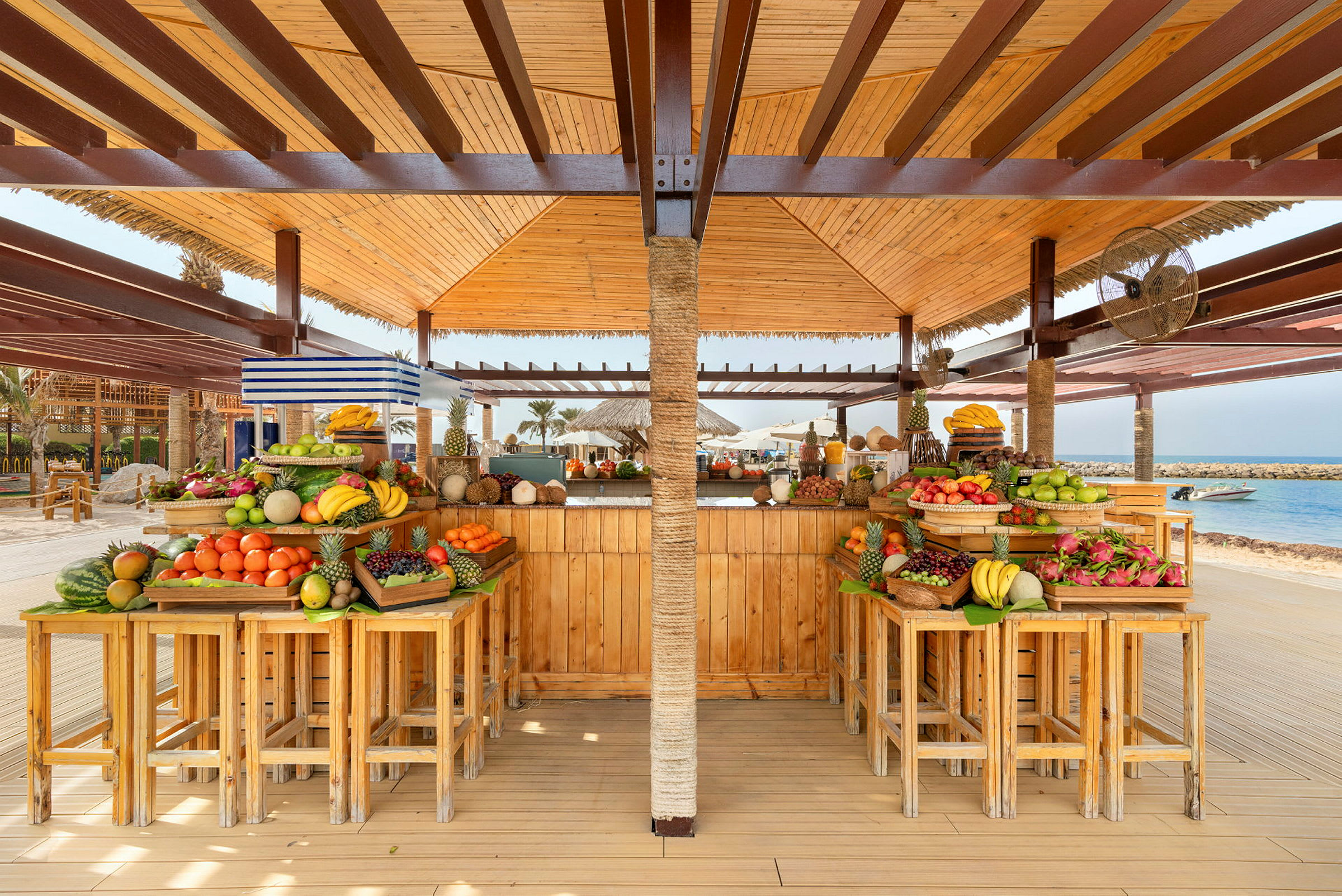 En strandbar med et utvalg av frisk frukt på trebord. (AI-generert tekst)