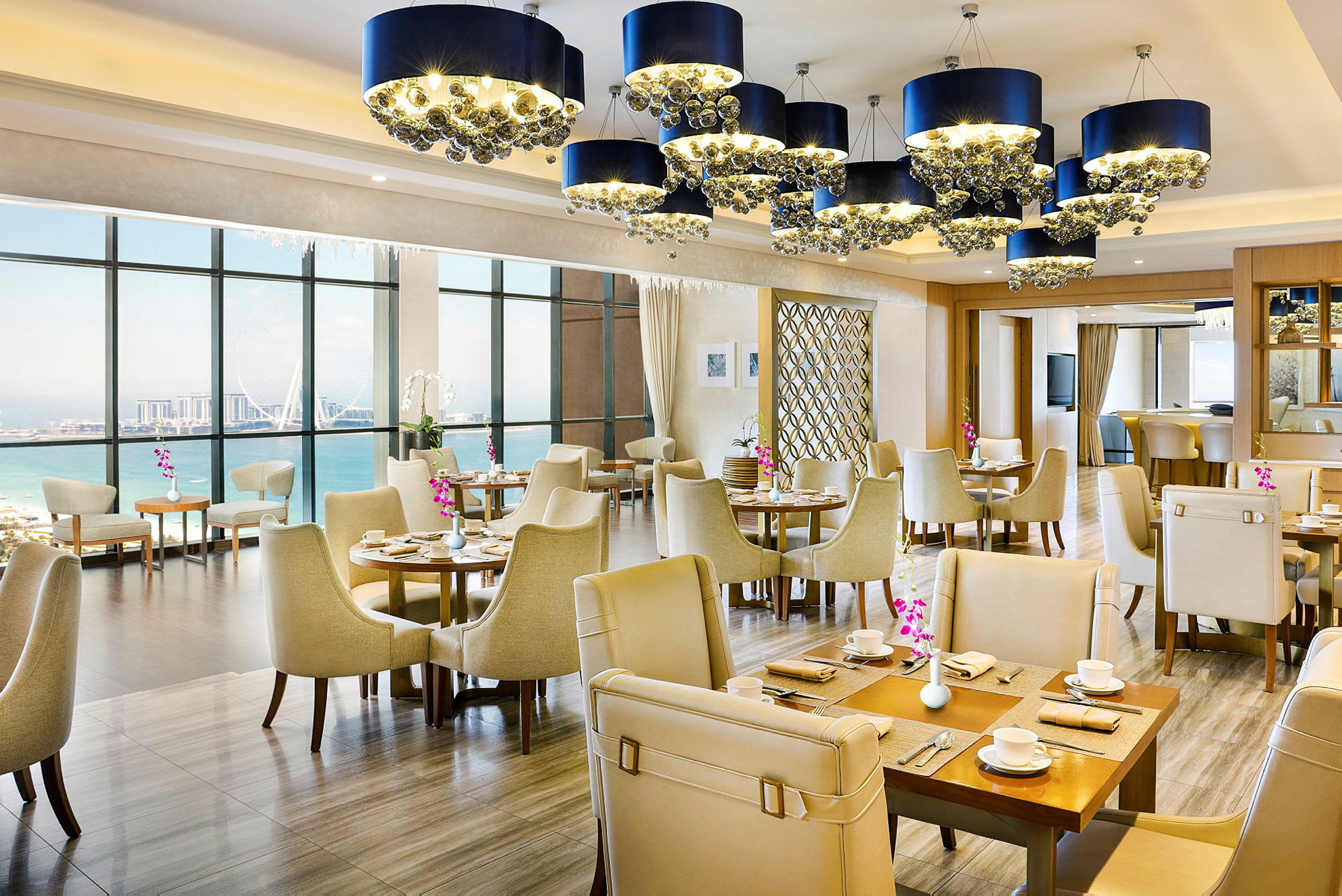 Interiør av en restaurant med elegante møbler og vinduer som vender mot havet. (AI-generert tekst)