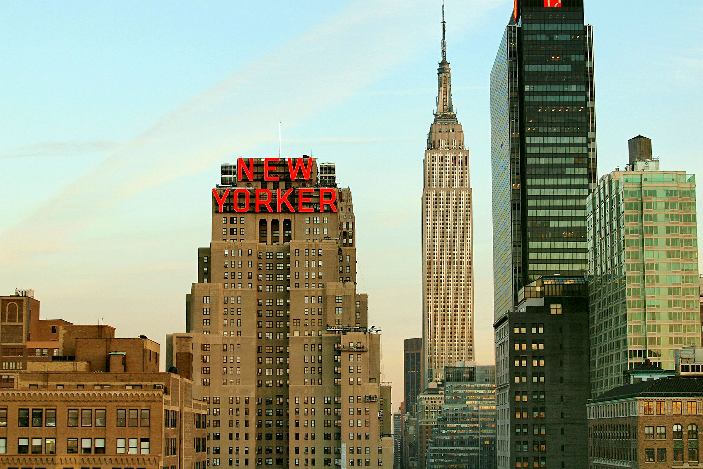Et bilde av byens silhuett med en bygning merket "New Yorker" og omkringliggende skyskrapere. (AI-generert tekst)