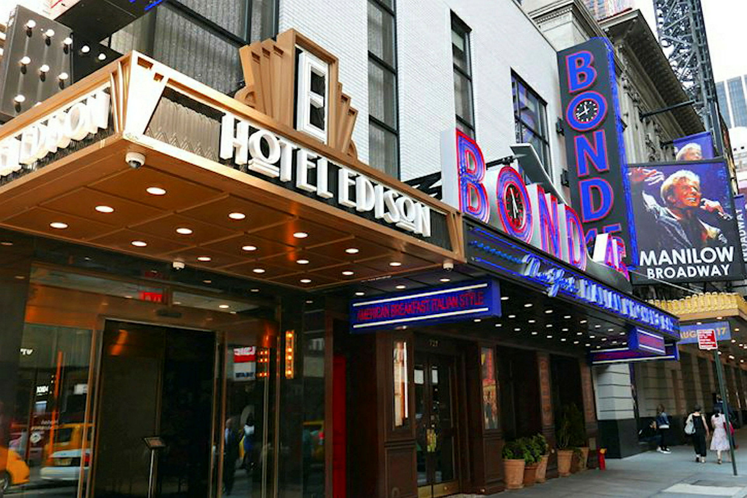 Et bilde av inngangen til Hotel Edison og et skilt for Bond 45 på en travel gate. (AI-generert tekst)