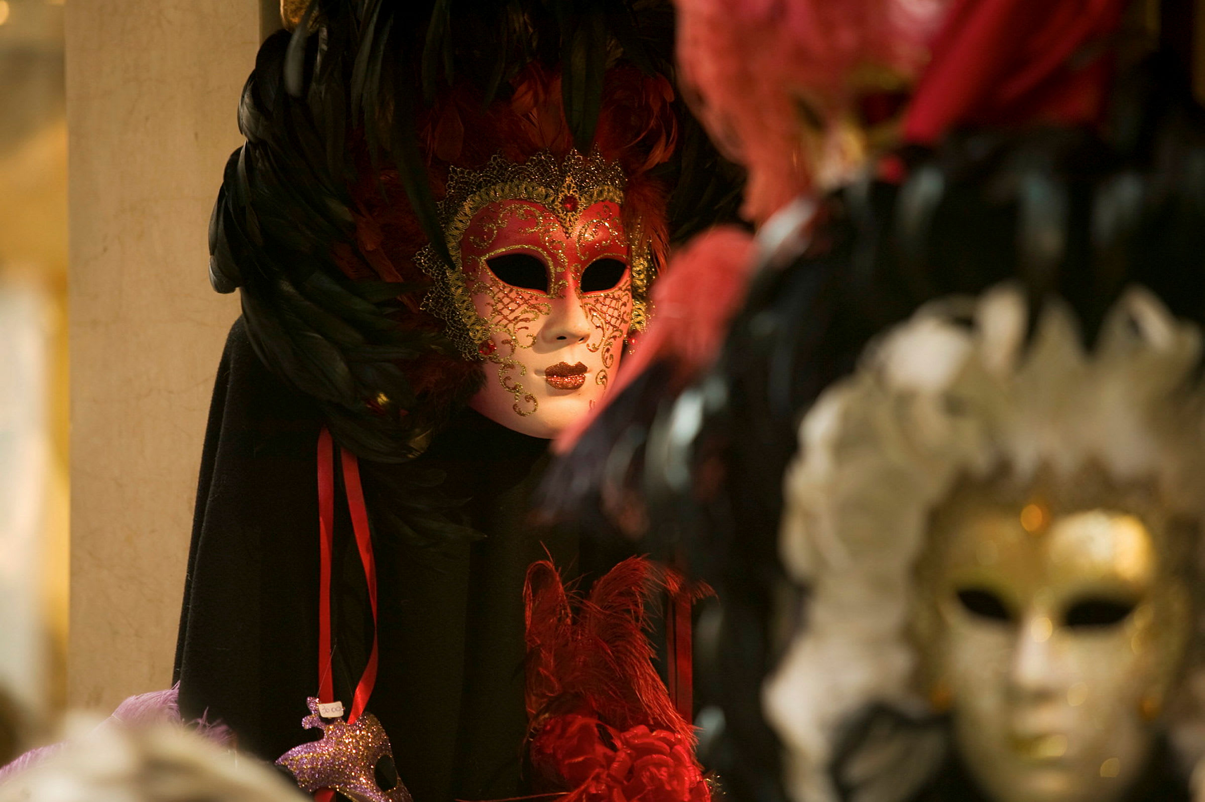 Et nærbilde av en dekorert maske med fjær og detaljer i gull, designet for maskerade. (AI-generert tekst)