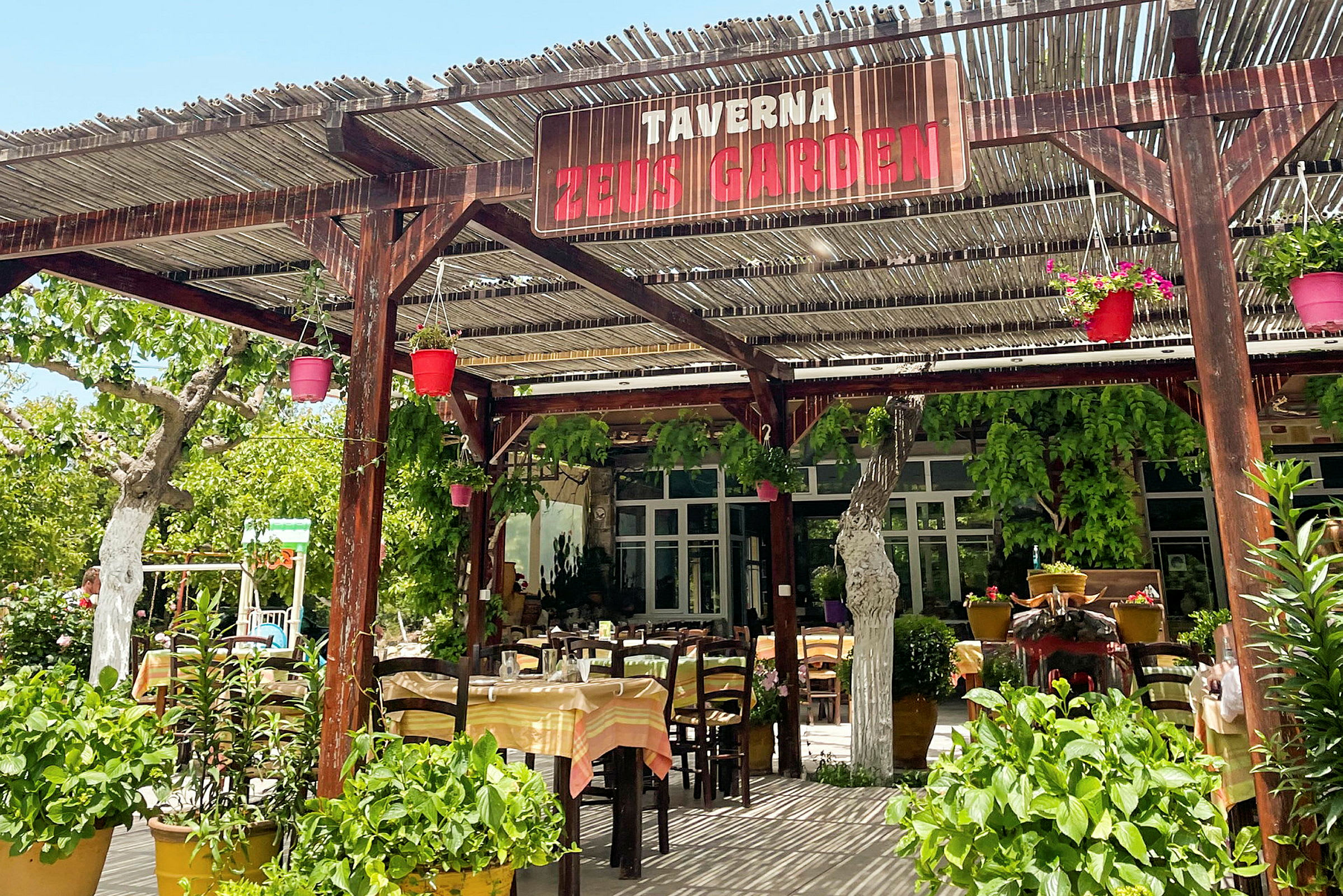 En taverna med uteservering og grønne planter. (AI-generert tekst)