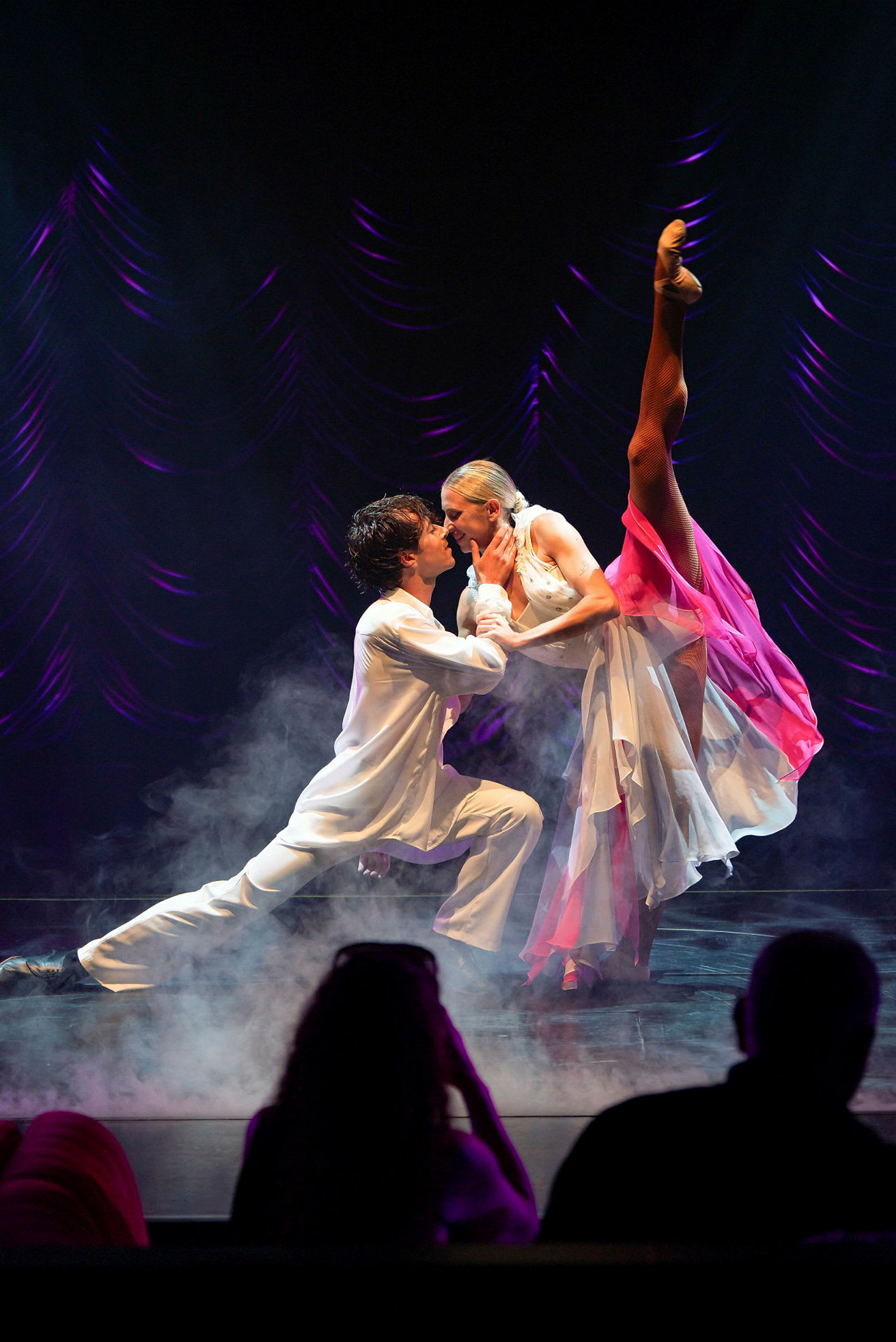 To personer danser på en tåkefylt scene foran et publikum. (AI-generert tekst)